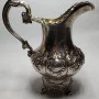 Silver milk jug with gilding in the middle