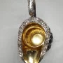 Silver milk jug with gilding in the middle