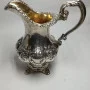 Silver milk jug with gilding in the middle