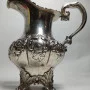 Silver milk jug with gilding in the middle